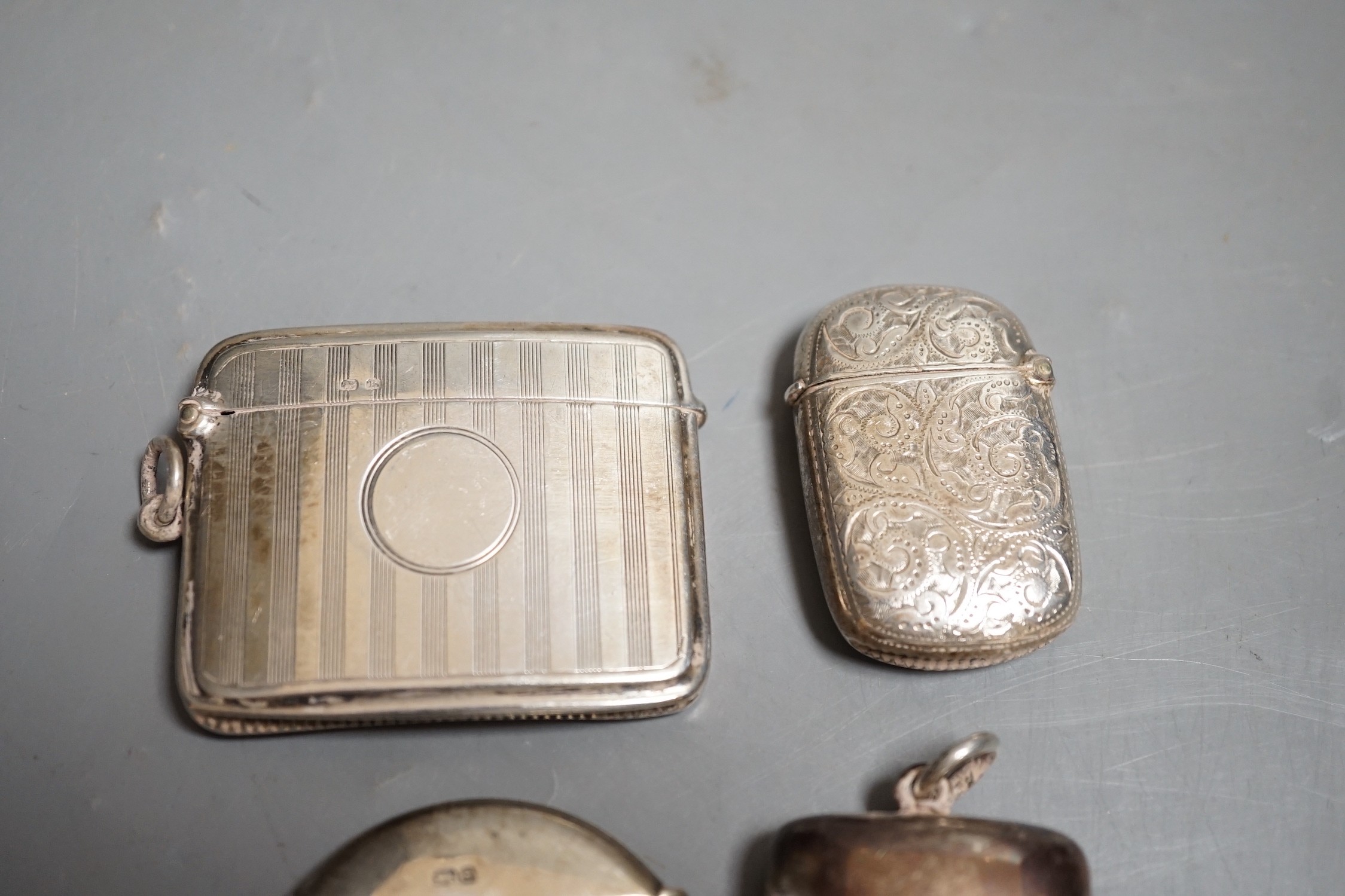 Four assorted late 19th/early 20th century silver vesta cases, including circular, 42mm.